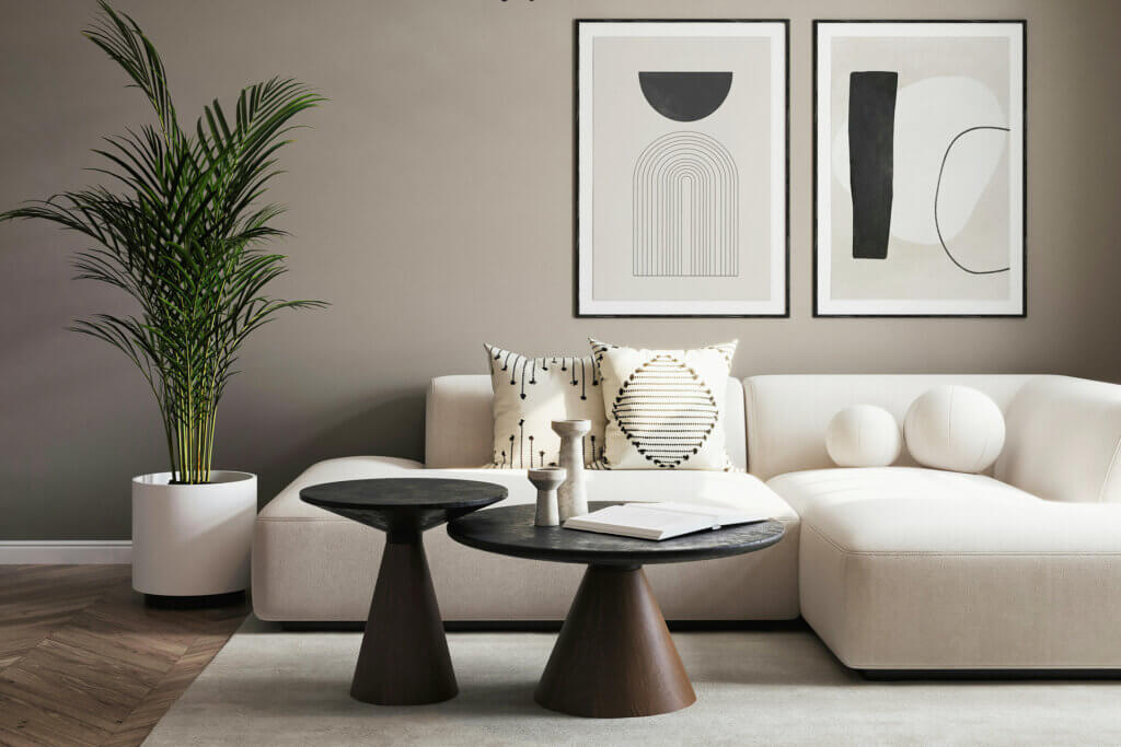 Minimalist living room with curved white sofa and geometric black side tables