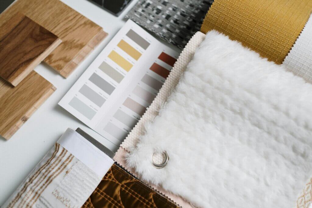 Fabric swatches and wood samples arranged for design planning, highlighting B2B furniture customization options.